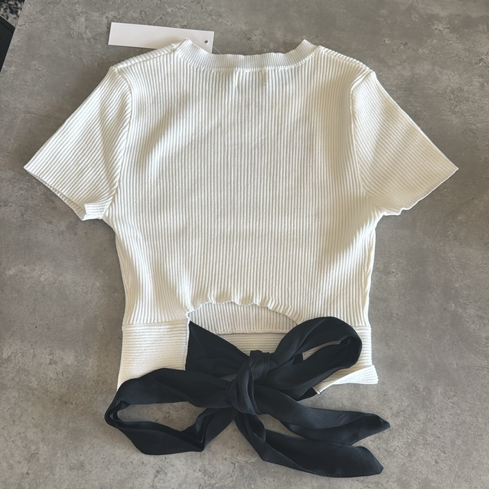 Elegant White Top with Black Bow Accent